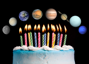 A birthday cake with lots of calndles which are alight. Above them are images of each planet in our Solar System